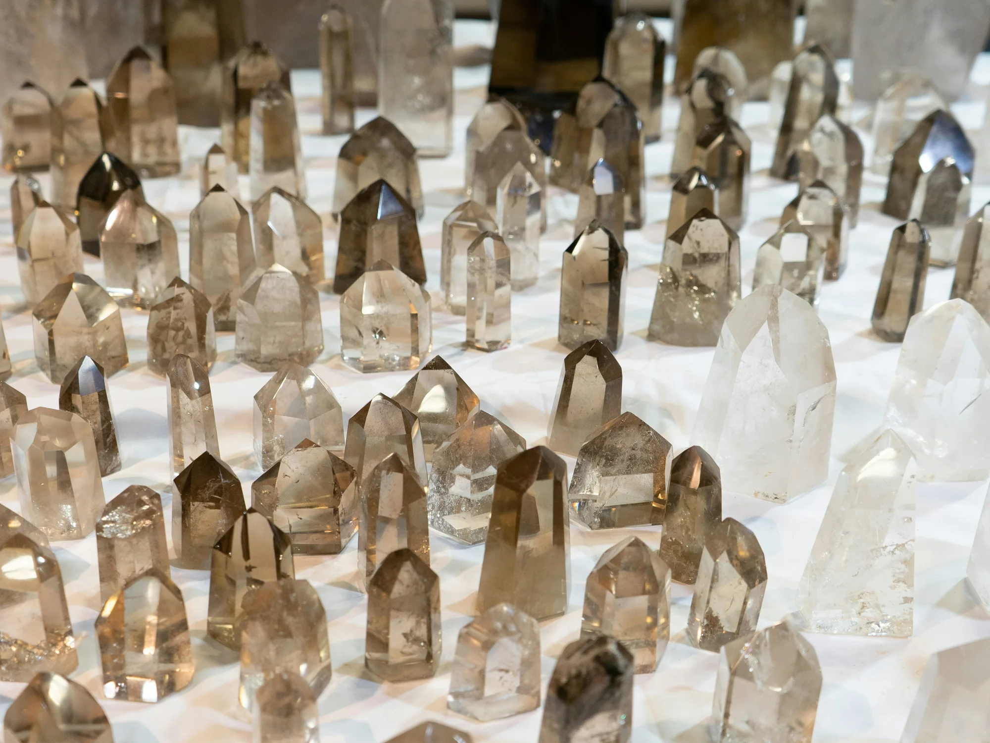 Rows of clear and smoky quartz points displayed together